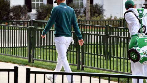 Dustin Johnson walks off the first tee after deciding not to play in the opening round of the 81st Masters tournament at the Augusta National Golf Club, Thursday April 6, 2017. Johnson was reportedly injured Wednesday afternoon at his rental residence when he fell down a short flight of steps. BRANT SANDERLIN / SPECIAL