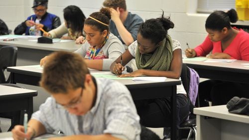 October 7, 2014 Lawrenceville - Seniors Nia Lucas, (center left), 16, and Brianna Mullin (center right), 17, take their mid-exam at AP Calculus AB class at The Gwinnett School of Math, Science & Technology on Tuesday, October 7, 2014. Georgia’s redesigned school report card, known as the CCRPI, gives schools extra points for things like successful completion rates of AP courses. HYOSUB SHIN / HSHIN@AJC.COM