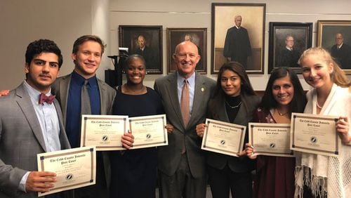 Kell High School students/Peer Court Law School graduates receive congratulations from Cobb District Attorney Vic Reynolds, the keynote speaker during their recent swearing-in ceremony. They are (l-r) Milad Jabbari, Matt Jones, Hannah Jackson, Reynolds, Ariana Arteaga, Anna Long and Zoe Buffington. Courtesy of Cobb County