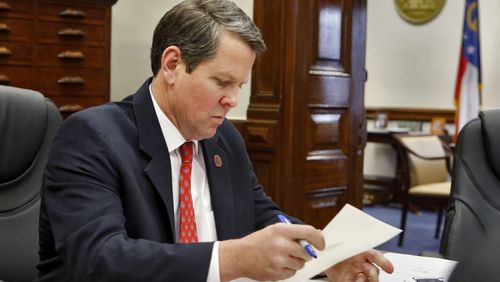 Georgia Secretary of State Brian Kemp in a staff meeting at his office in the Capitol last year. BOB ANDRES / BANDRES@AJC.COM