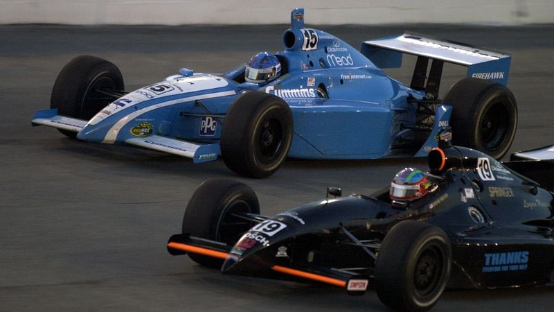 Sarah Fisher (No. 15) races next to Stevie Reeves (No. 19) during the IRL Midas 500 Classic July 15, 2000, at Atlanta Motor Speedway in Hampton. (Sunny Sung/AJC)