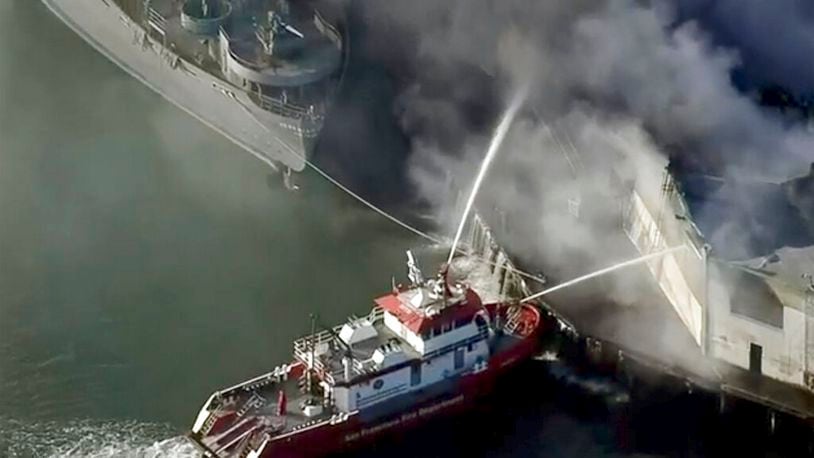 First responders battle a massive fire that erupted at a warehouse early Saturday, May 23, 2020 in San Francisco. Arriving crews were confronted with towering flames engulfing the warehouse.  (KPIX-TV CBS-Viacom via AP)