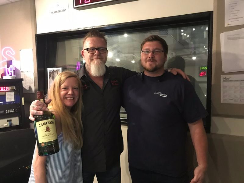 Kara Stockton and Shannon Burke pose with Jacob Boyak,  fan of the show at 10:45 a.m. on May 31, 2019. Boyak brought a 1.5 liter bottle of Jameson whiskey as a gift to the team.