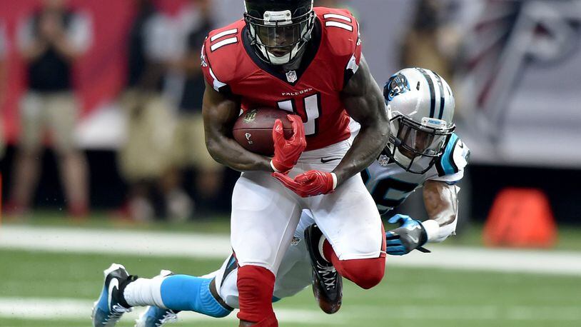 October 2, 2016 Atlanta: Atlanta Falcons wide receiver Julio Jones hauls in a Matt Ryan pass in front of Carolina Panthers cornerback Daryl Worley in the Georgia Dome Sunday October 2, 2016. Jones set a franchise record with 12 receptions and 300 yards and 1 touchdown. The performance was the 6th-highest receiving yardage game in NFL history. BRANT SANDERLIN/BSANDERLIN@AJC.COM