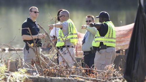 May 15, 2017: Three men were killed and another escaped and is on the run after a chase ended with a crash into a pond on Flint River Road. The two-county chase began when Fayetteville police received a 911 call from a Sprint company security guard about 4:20 a.m. JOHN SPINK/JSPINK@AJC.COM
