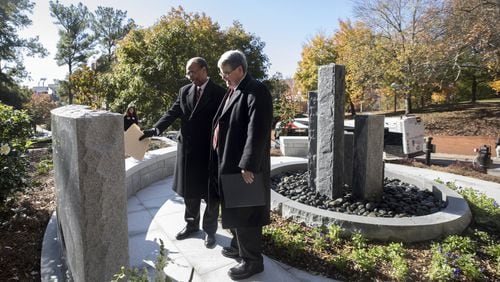 Judge Steve Jones, U.S. District Court Judge for the Northern District of Georgia, and UGA President Jere W. Morehead read the inscription at the Baldwin Hall Memorial. Credit: University of Georgia