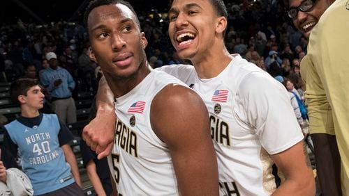 Georgia Tech’s Justin Moore, right, celebrates with teammate Josh Okogie (5) after the Yellow Jackets’ upset victory against North Carolina on Saturday. Tech won 75-63. (AP Photo/John Amis)