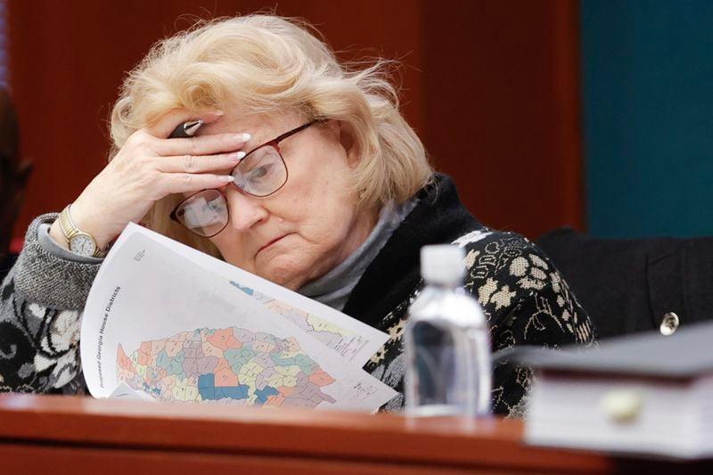 Rep. Darlene Taylor, R-Thomasville, flips through a packet with revised House district maps during a hearing at the Georgia State Capitol on  Nov 29, 2023. State attorneys urged a federal judge to reject arguments from Democrats that Georgia’s new GOP-drawn political boundaries are unconstitutional. (Natrice Miller/ natrice.miller@ajc.com)