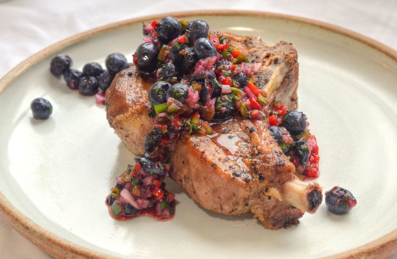 This recipe for Pork Chops with Blueberry Salsa is from Georgia Grown executive chef Holly Chute. STYLING BY WENDELL BROCK / CONTRIBUTED BY CHRIS HUNT PHOTOGRAPHY
