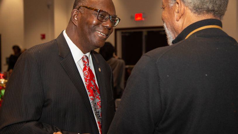 Clark Atlanta University President Ronald A. Johnson (left) talks with Dr Herbert Eichelberger during a holiday party at the Henderson Student Center on campus in Atlanta on Friday, Dec. 7, 2018. Johnson is retiring this month. (Photo by Phil Skinner)