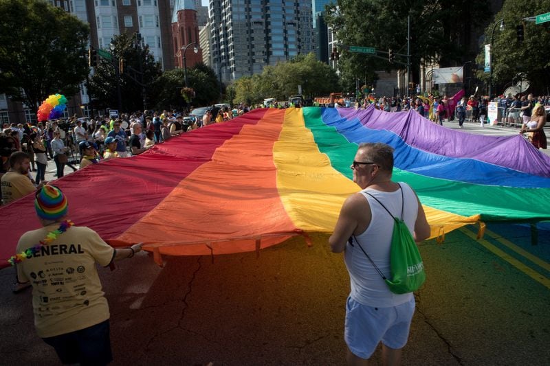 A giant rainbow flag makes its way down Peachtree Street during the Atlanta Pride Parade Sunday in Atlanta October 14, 2018. Photo: STEVE SCHAEFER / SPECIAL TO THE AJC