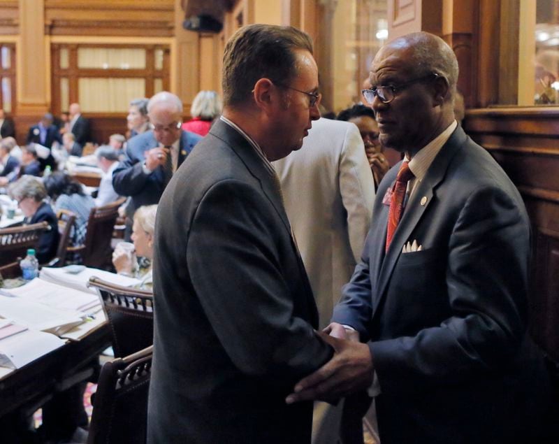 Rep. Calvin Smyre (right), D - Columbus, congratulates Rep. Kevin Tanner, R - Dawsonville, after the passage of HB 930, the mass transportation bill. BOB ANDRES /BANDRES@AJC.COM
