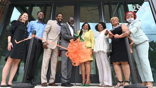 July 1, 2021 Atlanta - Leonard Adams, Jr. (center left), Founder of Quest Community Development Organization,  and Olivia D.A. Maxwell (center right), executive director of On the Rise Financial Center, cut the ribbon during an opening event of On the Rise Financial Center and Quest Westside Impact Center in Atlanta on Thursday, July 1, 2021. On The Rise Financial Center opens a new office and community space in a new building near the corner of Joseph E. Boone Boulevard and Joseph E. Lowery Boulevard. The On The Rise center assists residents with one-on-one financial coaching, including preparation for buying a home or starting a new business. It also gives people access to local credit union products including banking services. The center is supported financially though Equifax, as well as Invest Atlanta and the Arthur M. Blank Foundation. (Hyosub Shin / Hyosub.Shin@ajc.com)
