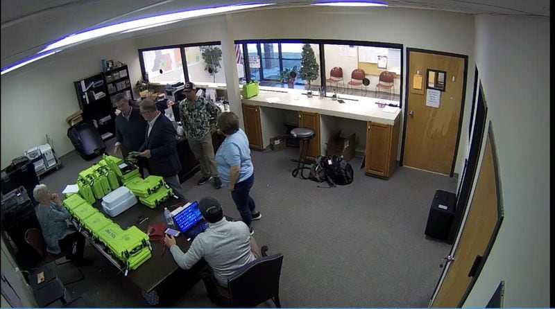 Surveillance video of the Coffee County elections office shows green voter check-in tablets, called PollPads, on a table while tech experts and Trump supporters examined elections equipment on Jan. 7, 2021. 
Source: Coffee County