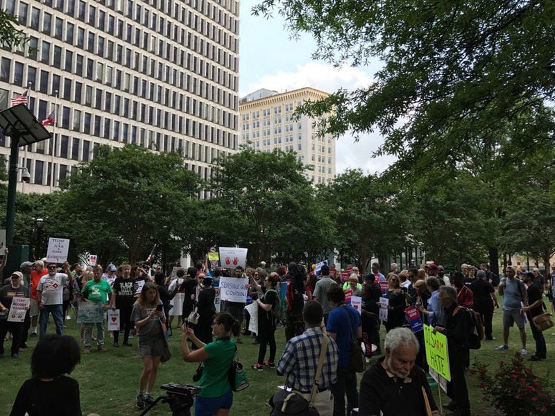 Protesters at Woodruff Park began gathering for a "die-in," representing the number of people killed by guns each year. They are protesting President Donald Trump's speech to the National Rifle Association convention in downtown Atlanta.