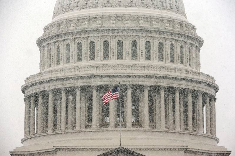 Snow falls around the US Capitol Building in Washington. (Pablo Martinez Monsivais/AP)