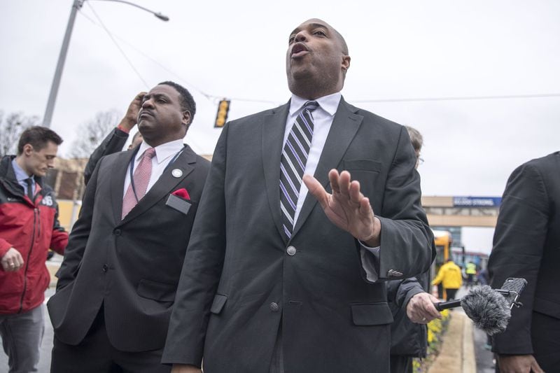 Clayton County Public Schools deputy superintendent, Anthony W. Smith, left, stands in support of superintendent Morcease Beasley, center, as he speaks near the entrance of the Delta Air Lines headquarters to protest Georgia House Bill 821 on Tuesday, Feb. 13, 2018. ALYSSA POINTER/ALYSSA.POINTER@AJC.COM