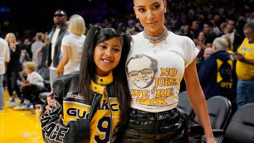 FILE - Kim Kardashian poses for a photo with daughter North West before Game 6 of an NBA basketball Western Conference semifinal series against the Golden State Warriors in Los Angeles on May 12, 2023. West sill join the cast of A starry “Lion King” concert, that is set to run May 24-25 at the Hollywood Bowl. (AP Photo/Ashley Landis, File)