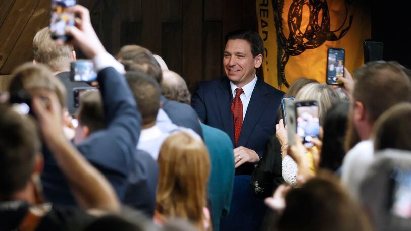 Florida Gov. Ron DeSantis greets supporters as he arrives at an event spotlighting his newly released book, "The Courage To Be Free: Florida's Blueprint For America's Revival," at the Adventures Outdoors on Thursday, March 30,  in Smyrna. Miguel Martinez / miguel.martinezjimenez@ajc.com