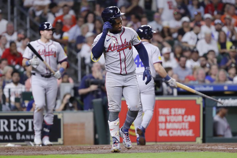 Ozzie Albies limps to first base after getting hit by a pitch in the foot during the second inning of Monday's game against the Astros in Houston. (AP Photo/Michael Wyke)