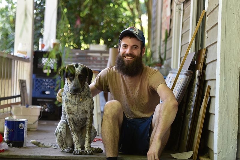 June 5, 2015 Atlanta - Portrait of Nathan Tavel, 26, with his dog Lola at his home in Grant Park on Friday, June 5, 2015. Nathan Tavel is a professional sign painter, so he's up on ladders a lot. And, he bikes everywhere; he doesn't own a car. When he turned 26 last fall, he lost insurance that his parents had been able to provide for him. "Without, it (the subsidy), I'd be without insurance, " said Tavel. HYOSUB SHIN / HSHIN@AJC.COM