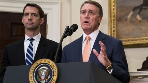 Sen. David Perdue, R-Ga., (foreground) and Sen. Tom Cotton, R-Ark., deliver a statement after President Donald Trump announced proposed immigration legislation at the White House, in Washington, Aug. 2, 2017. (Doug Mills/The New York Times)