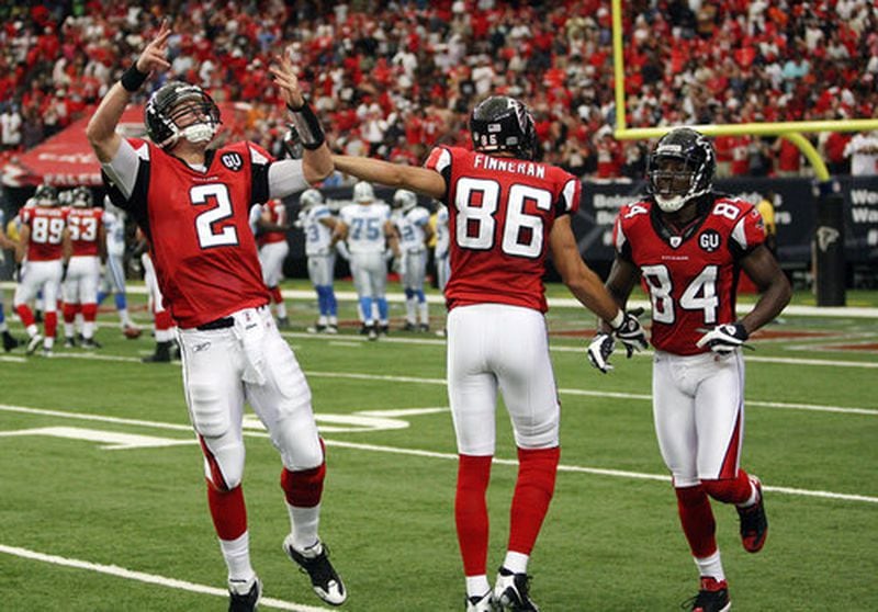 Matt Ryan acknowledges the crowd as he celebrates a touchdown pass to Michael Jenkins with teammates Brian Finneran and Roddy White.