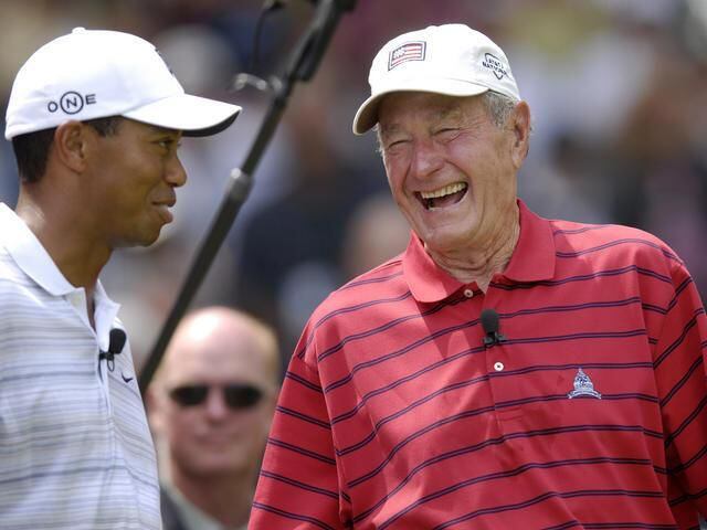 Tiger Woods, golfer, and George H. W. Bush, former US President (l-r), laugh together during the AT&T Earl Woods Memorial Pro-Am, Bethesda, Maryland, in July of 2007.