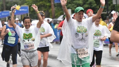 Lot of waving going on during last year’s AJC Peachtree Road Race on Saturday, held on July 4, 2015. HYOSUB SHIN / HSHIN@AJC.COM
