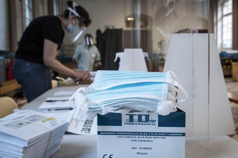 Protective face masks are pictured in a polling station during the second round of the municipal elections, Sunday, June 28, 2020 in Paris. France is holding the second round of municipal elections in 5,000 towns and cities Sunday that got postponed due to the country's coronavirus outbreak. (Joel Saget, Pool via AP)