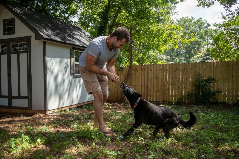 09/02/2020 - Decatur, Georgia - Garrett Korn uses a frisbee to play catch with his dog Kira at his residence in Decatur, Wednesday, September 2, 2020. (Alyssa Pointer / Alyssa.Pointer@ajc.com)