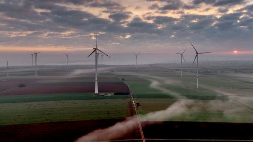 FILE - Wind turbines operate at an energy plant near Stetten, north of Kaiserslautern, Germany, as the sun rises on, March 19, 2024. According to a new report published Tuesday, April 16, 2024, last year, marked the best year for new wind projects. (AP Photo/Michael Probst, File)