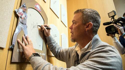 Hall of Fame inductee and former Atlanta Braves slugger Chipper Jones signs the spot where his Hall of Fame plaque will hang during an orientation tour of the National Baseball Hall of Fame in Cooperstown, N.Y., Tuesday, April 10, 2018.