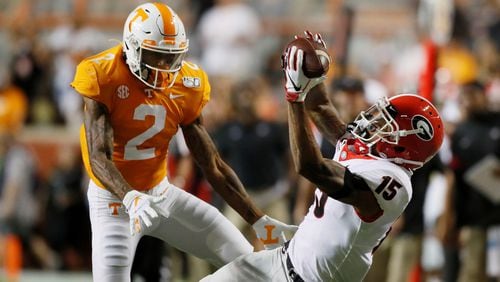 Georgia Bulldogs wide receiver Lawrence Cager (15) appeared to make a dramatic catch for a first down in the second quarter, defended by  Tennessee Volunteers defensive back Alontae Taylor (2), but on review it was ruled incomplete during todays UGA vs Tennessee NCAA football game at Neyland Stadium in Knoxville.  Bob Andres / robert.andres@ajc.com