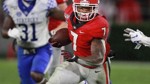 University of Georgia tailback D’Andre Swift picks up yardage against Kentucky in an NCAA college football game Saturday in Athens. State Rep. Billy Mitchell, D-Stone Mountain, is proposing a bill modeled on similar legislation in California that would allow college athletes to be paid. Curtis Compton/ccompton@ajc.com