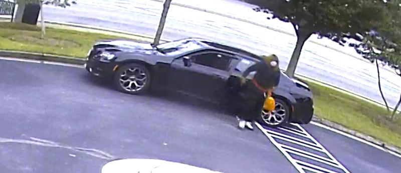 The serial bank robber drives what appears to be a newer model Chrysler 300 with chrome rims.