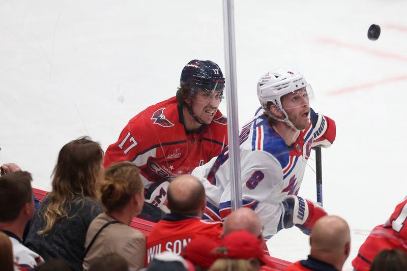 New York Rangers defenseman Jacob Trouba (8) and Washington Capitals center Dylan Strome (17) battle for puck possession during the third period in Game 3 of an NHL hockey Stanley Cup first-round playoff series, Friday, April 26, 2024, in Washington. (AP Photo/Tom Brenner)