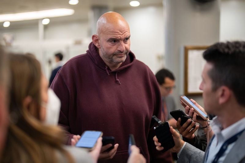 U.S. Sen. John Fetterman, D-Pa., who is known for wearing hoodies and shorts instead of suits, speaks to reporters on Capitol Hill in Washington on Tuesday, Sept. 26, 2023. A week after the top Senate Democrat announced a more casual standard for dress in the chamber, a bipartisan pair won passage of a measure requiring that business attire be worn. (Maansi Srivastava/The New York Times)
                      