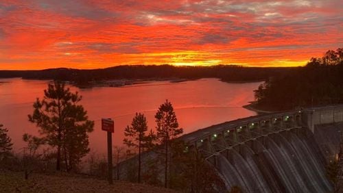 The sun rises over the Etowah River dam at Allatoona Lake. Park management is seeking candidates to bid on a seasonal park attendant position at Sweetwater Campground on the lake. U.S. ARMY CORPS OF ENGINEERS via Facebook