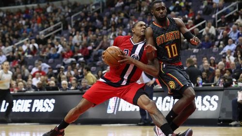 Bradley Beal of the Washington Wizards drives to the basket against Tim Hardaway Jr. of the Atlanta Hawks in the first half at Verizon Center on March 22, 2017 in Washington, DC. (Photo by Rob Carr/Getty Images)