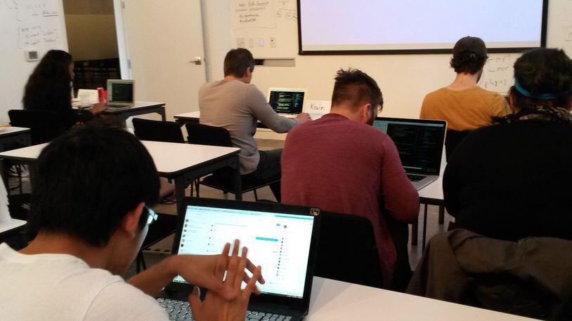 Metro Atlanta is awash in for-profit coding classes. Here, students hunch over laptops at General Assembly, which opened a classroom at Ponce City Market in Atlanta last year.