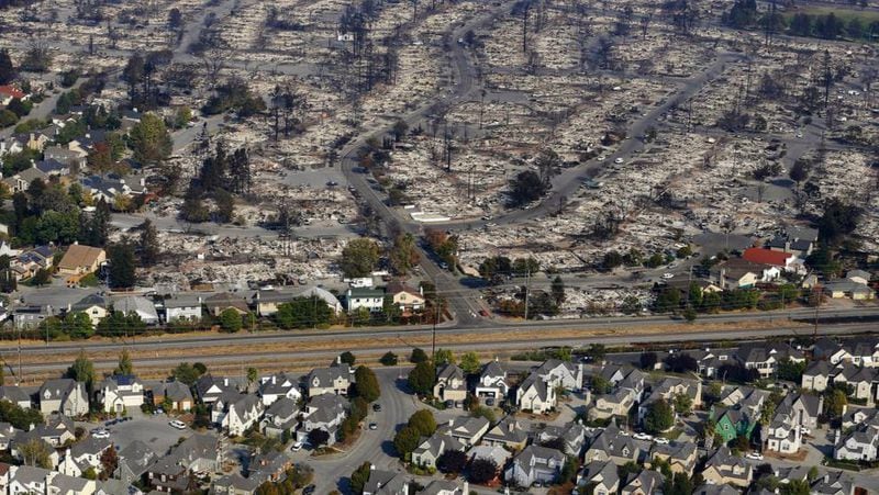 Homes destroyed by fire are seen in an aerial view in Santa Rosa, Calif., on Wednesday, Oct. 11, 2017. Natasha Wallace's home in the city was destroyed as she fled on a bike with her pit bull in a duffel bag.