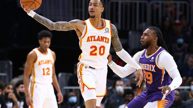 Hawks forward John Collins (20) is still recovering from a right foot strain. (Curtis Compton / Curtis.Compton@ajc.com)