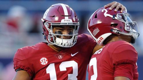 Tua Tagovailoa and Jalen Hurts of the Alabama Crimson Tide talk prior to the game against the Louisville Cardinals at Camping World Stadium on Sept. 1, 2018 in Orlando.