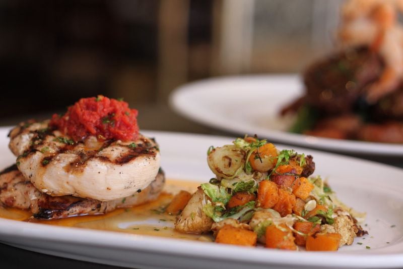 At Marlow's Tavern, the Grilled Chicken comes with butternut squash, shaved Brussels, cumin charred cauliflower, tomato concasse and roast chicken jus. (Courtesy of Marlow’s Tavern)