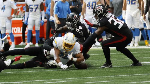 Chargers running back Austin Ekeler fumbles the ball late in the fourth quarter Sunday against the Falcons at the Mercedes-Benz Stadium. The ball was recovered by Falcons linebacker Ta'Quon Graham (not pictured), but moments later, he lost it. (Miguel Martinez / miguel.martinezjimenez@ajc.com)