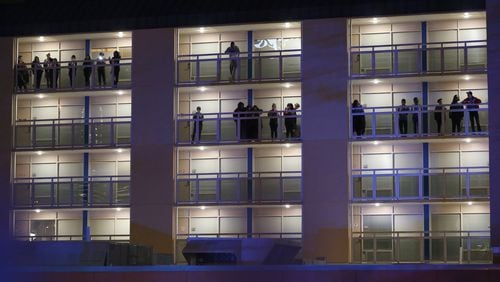 Students watch from the balconies of Georgia State University’s Piedmont North residence hall as police investigate a double shooting on the property Monday night, March 21, 2016. Ben Gray / bgray@ajc.com