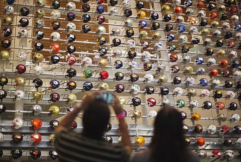 A three-story-high wall of helmets displays the headgear of the 768 teams that play college football at several different levels.