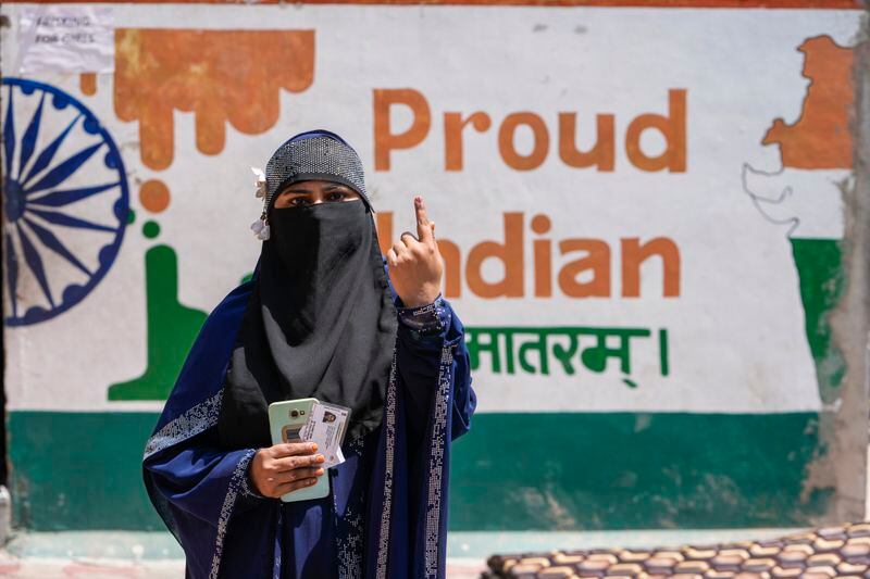 A woman shows the indelible ink mark on her index finger after casting her vote during the third phase of general elections, in Ahmedabad, India, Tuesday, May 7, 2024. (AP Photo/Ajit Solanki)