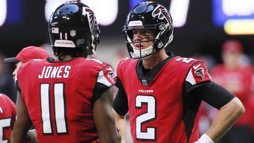 Atlanta Falcons wide receiver Julio Jones (11) and quarterback Matt Ryan (2) confer in the huddle after they failed to connect on a pass attempt against the Baltimore Ravens Sunday, Dec. 2, 2018, at Mercedes-Benz Stadium in Atlanta.